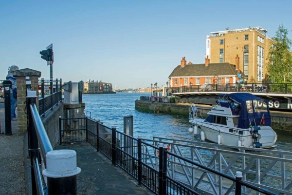 Yatch passes the open Narrow Street Swing Bridge