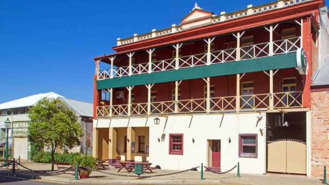Built 1878-83; Three storey brick building; hipped corrugated iron roof; 1st and 2nd-floor verandahs with timber posts and cross braced balustrades; 98 Wharf Street; Qld Register #600719