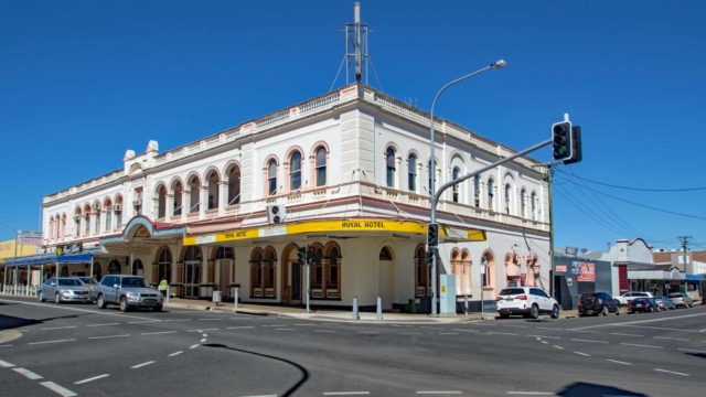 Built 1892-1923; Style -classicism; Two storeys - rendered masonry; hipped corrugated iron roof concealed by a parapet; 1st floor arched loggias; cantilevered street awning; Kent Street; Qld Register #600700. Queensland Pubs